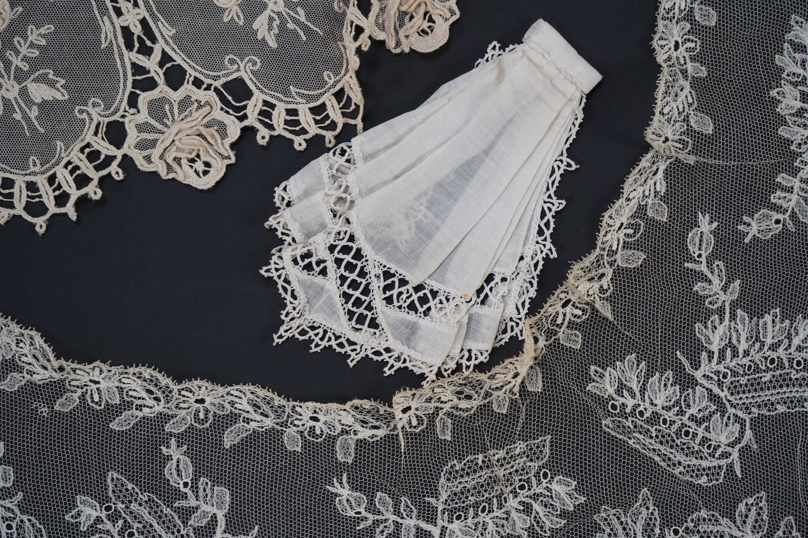 A variety of 19th and 20th century cream lace, being mixed hand and machine collars, lappets, trimmings together with a silk stole. Ideal for tv, film and theatre, stole 230 cm long. Condition - good